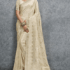 Elegant cream Banarasi silk saree with woven jacquard floral motifs and rich border, paired with matching blouse, perfect for wedding, festive and party wear.