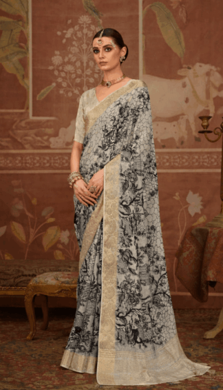 Woman wearing elegant off-white silk saree with black floral print and rich golden zari woven border, paired with matching blouse and traditional jewelry in a heritage-inspired setting.
