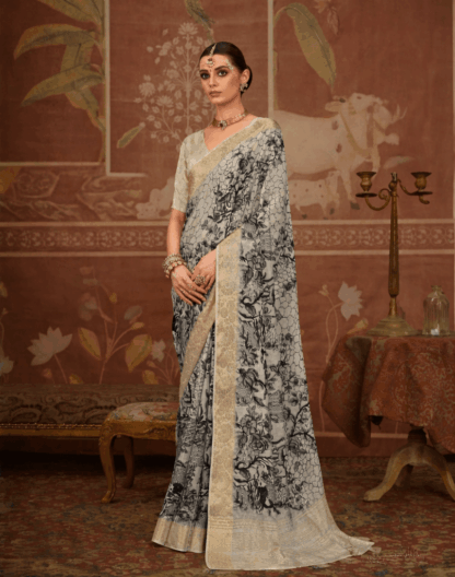 Woman wearing elegant off-white silk saree with black floral print and rich golden zari woven border, paired with matching blouse and traditional jewelry in a heritage-inspired setting.