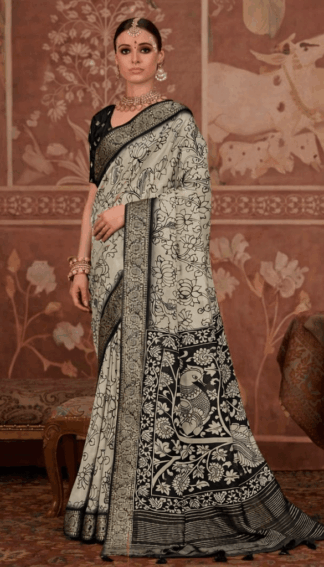 model wearing a black and ivory saree with intricate floral and peacock motifs, paired with a black blouse