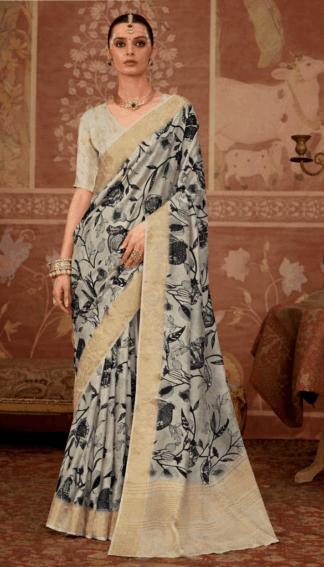 Model wearing an off-white floral printed silk saree with gold zari border, paired with matching blouse