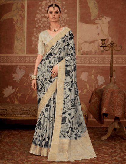 Model wearing an off-white floral printed silk saree with gold zari border, paired with matching blouse