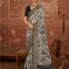 Model wearing a black and grey floral printed silk saree with intricate zari border, paired with a black blouse