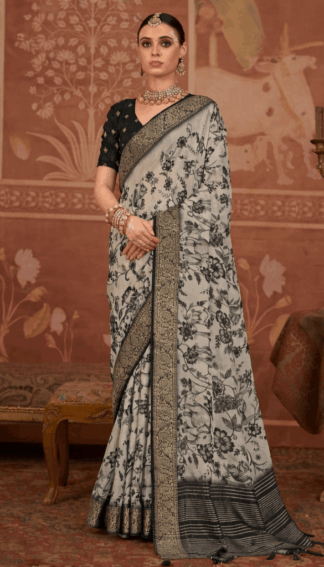 Model wearing a black and grey floral printed silk saree with intricate zari border, paired with a black blouse