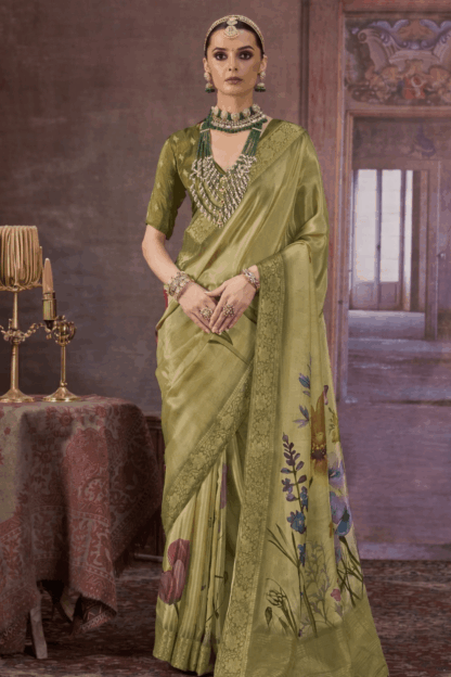 olive green Chinon silk saree with floral digital print and rich woven border, styled with traditional jewelry, perfect for festive and wedding occasions.