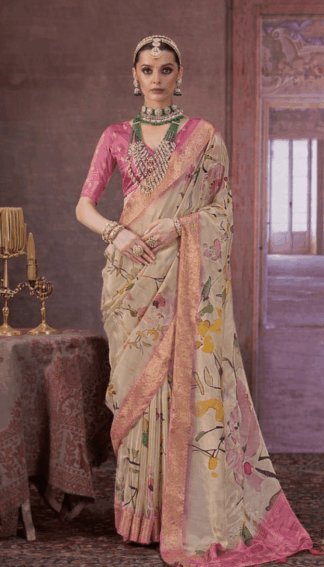 Elegant beige silk saree with pink blouse and floral print, featuring rich zari border and traditional bridal jewellery styling