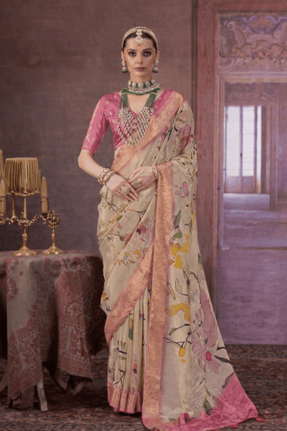 Elegant beige silk saree with pink blouse and floral print, featuring rich zari border and traditional bridal jewellery styling