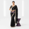 Black saree with embroidered border and small embroidered motifs with stiched heavy blouse.
