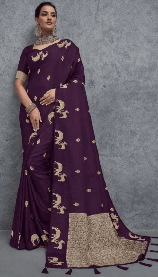 Elegant wine purple Banarasi silk saree with intricate golden zari woven motifs and rich traditional border, perfect for wedding, festive and party wear occasions.