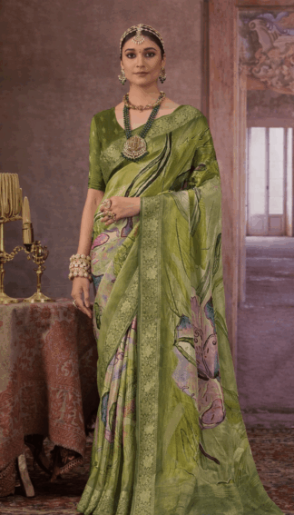 Model wearing a green floral printed silk saree with gold zari border.