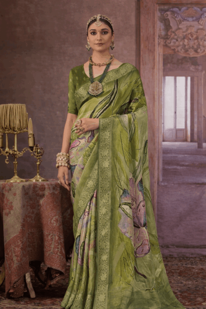 Model wearing a green floral printed silk saree with gold zari border.