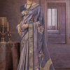 Steel grey silk saree with gold zari border, floral prints, and crane motif on the pallu.