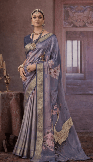 Steel grey silk saree with gold zari border, floral prints, and crane motif on the pallu.