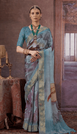 Sky blue silk saree with gold zari woven border and artistic abstract prints on the drape and pallu.